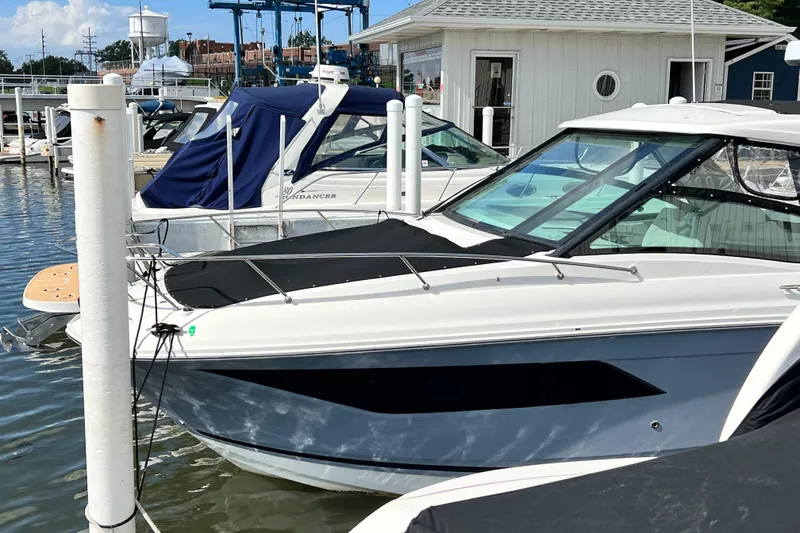 Slide: The Image of 2025 Sea Ray Sundancer 320 Outboard docked at marina, featuring sleek design and modern amenities. - 6
