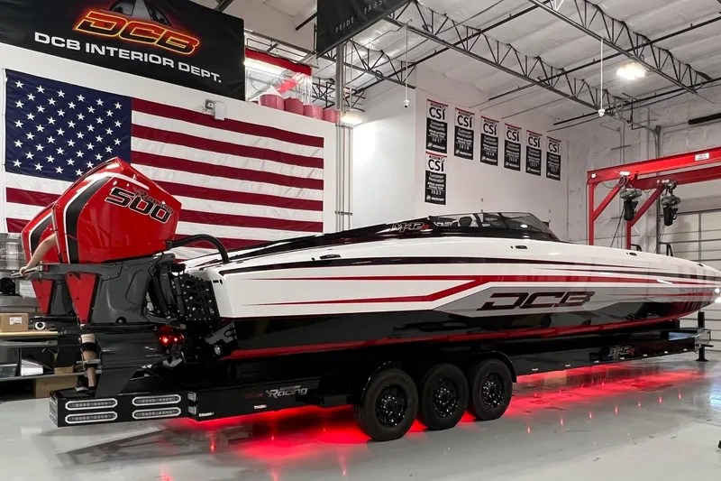 Slide: The Image of 2025 Daves Custom Boats M42R in showroom with American flag backdrop. - 1