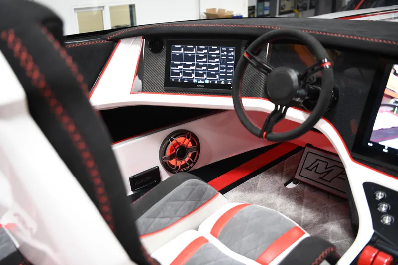 Slide: The Image of Interior of 2025 Daves Custom Boats M42R, featuring modern dashboard and steering wheel design. - 11
