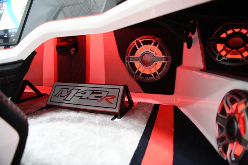 Slide: The Image of Interior of 2025 Daves Custom Boats M42R with illuminated speakers and modern design. - 21