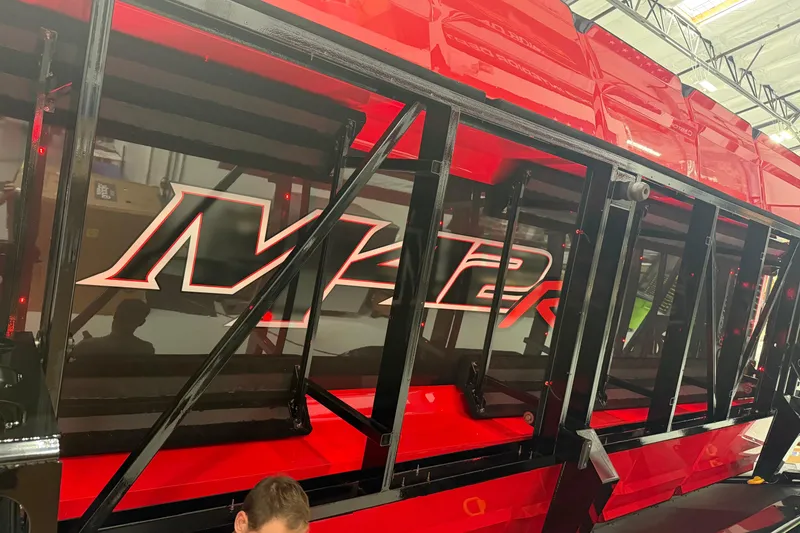 Slide: The Image of 2025 Daves Custom Boats M42R, vibrant red exterior, sleek design in a showroom. - 3