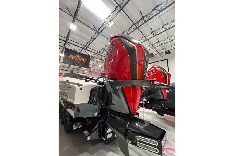 Slide: The Image of 2025 Daves Custom Boats M42R with powerful red outboard engines in a showroom. - 4