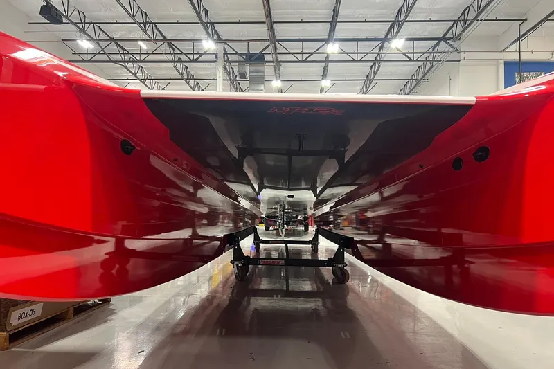 Slide: The Image of 2025 Daves Custom Boats M42R, red hull, in a well-lit showroom. - 5