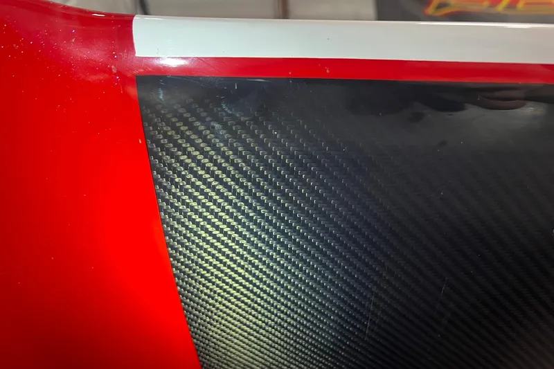 Slide: The Image of Close-up of 2025 Daves Custom Boats M42R with red and carbon fiber detailing. - 6