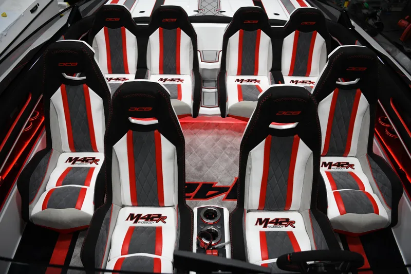 Slide: The Image of Interior of 2025 Daves Custom Boats M42R with red, white, and gray seating. - 9