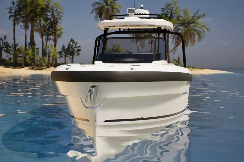 Slide: The Image of 2026 Wellcraft 28 T-Top boat on tropical water near palm-lined beach. - 1