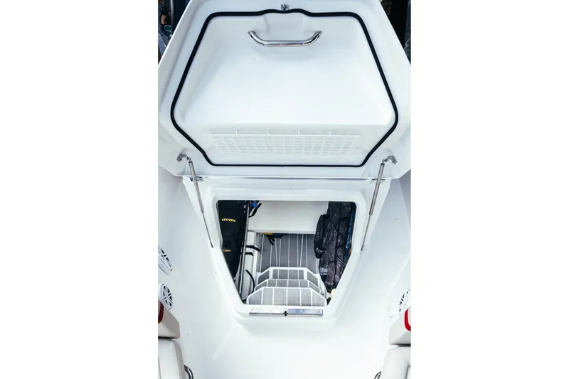 Slide: The Image of 2026 Wellcraft 28 T-Top boat interior storage compartment with organized gear and equipment. - 16