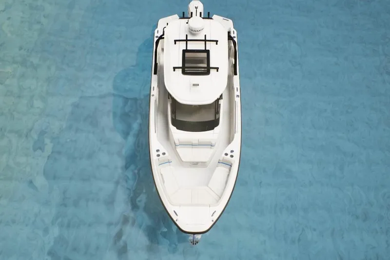 Slide: The Image of Top view of 2026 Wellcraft 28 T-Top boat on clear blue water. - 2