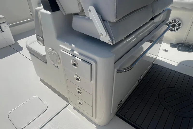 Slide: The Image of 2024 World Cat 325 CC boat interior with storage drawers and seating. - 10