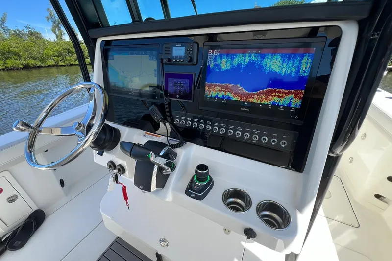 Slide: The Image of 2024 World Cat 325 CC boat dashboard with advanced navigation and control systems. - 13