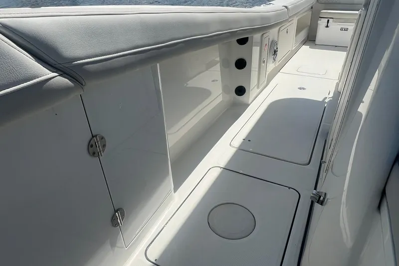 Slide: The Image of 2024 World Cat 325 CC boat interior with sleek white deck and storage compartments. - 15