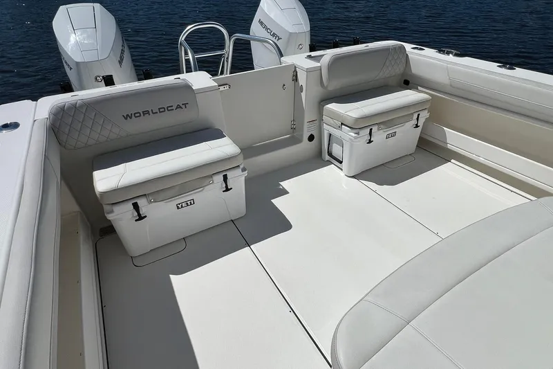 Slide: The Image of 2024 World Cat 325 CC boat interior with Yeti coolers and Mercury engines. - 9