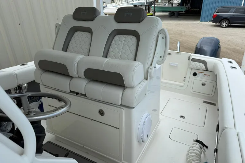 Slide: The Image of 2020 World Cat 280 CC-X boat interior with dual seats and steering wheel. - 10
