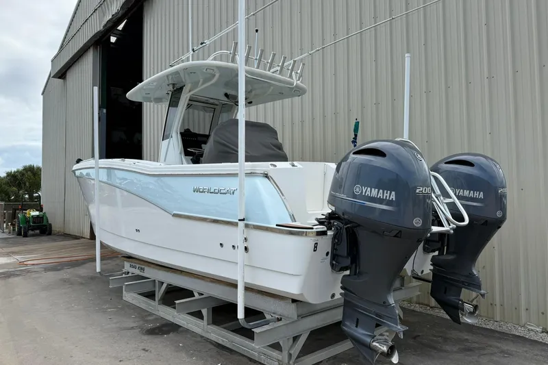 Slide: The Image of 2020 World Cat 280 CC-X boat with dual Yamaha engines in a storage facility. - 3