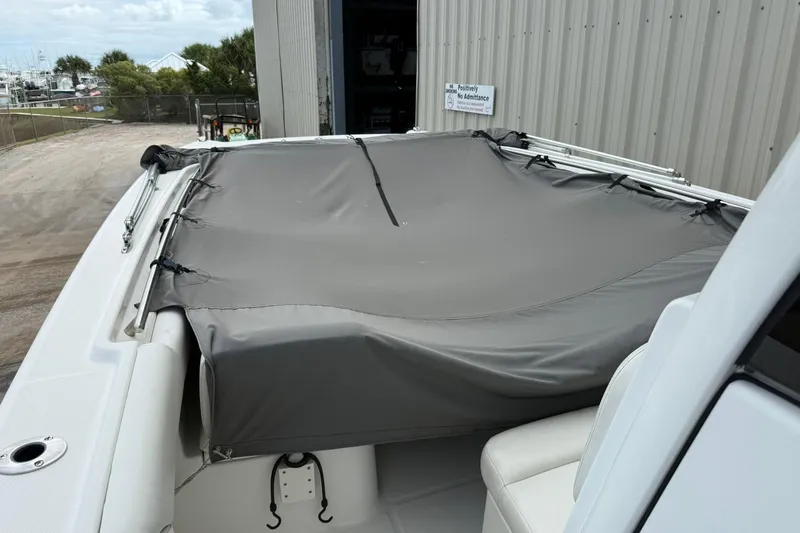 Slide: The Image of 2020 World Cat 280 CC-X boat with protective cover in a storage area. - 7