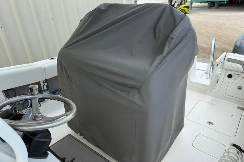 Slide: The Image of 2020 World Cat 280 CC-X boat helm covered with protective gray cover. - 8