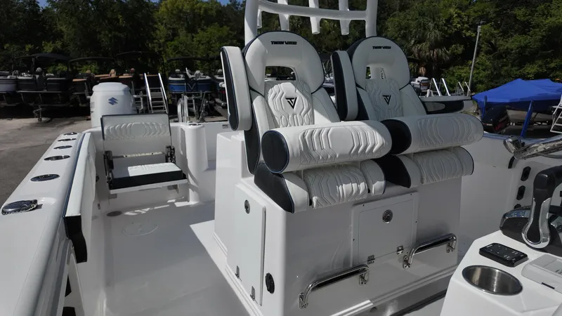 Slide: The Image of 2026 Twin Vee 280 GFX2 CC boat interior with luxurious seating and modern controls. - 11