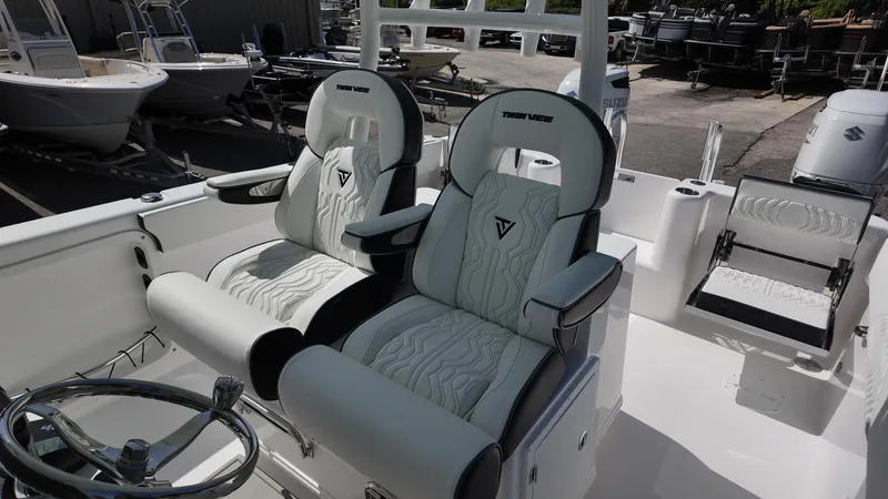 Slide: The Image of 2026 Twin Vee 280 GFX2 CC boat interior with luxurious seating and steering wheel. - 12