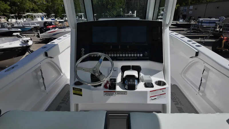 Slide: The Image of 2026 Twin Vee 280 GFX2 CC boat console with steering wheel and controls. - 14