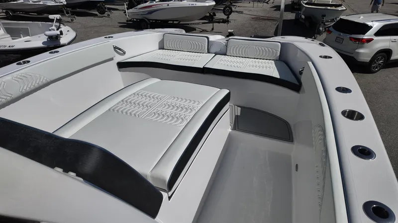 Slide: The Image of 2026 Twin Vee 280 GFX2 CC boat interior with white cushioned seating. - 19