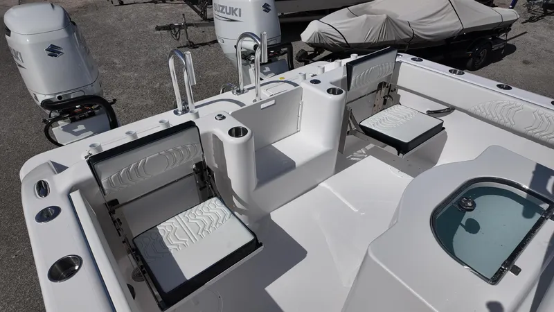Slide: The Image of 2026 Twin Vee 280 GFX2 CC boat interior with seating and Suzuki engines. - 22