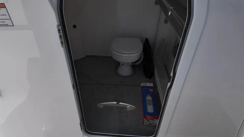 Slide: The Image of Interior of 2026 Twin Vee 280 GFX2 CC boat with toilet and fire extinguisher. - 25