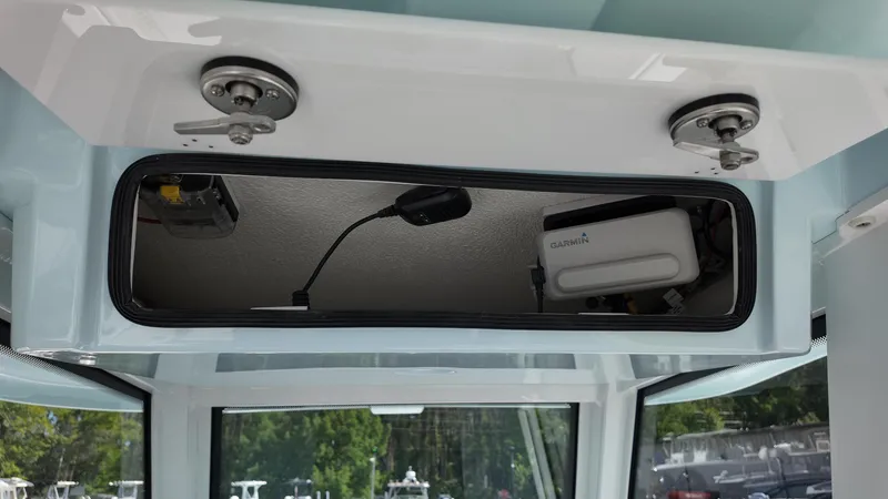 Slide: The Image of Interior storage compartment of 2026 Twin Vee 280 GFX2 CC boat with Garmin equipment. - 26