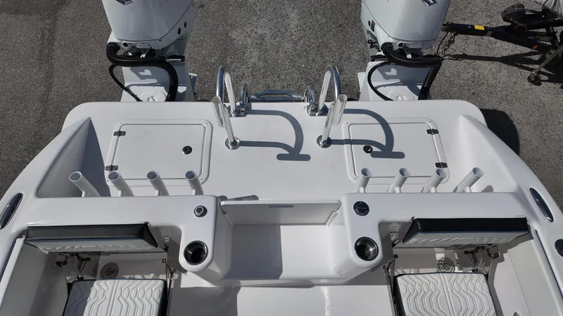 Slide: The Image of 2026 Twin Vee 280 GFX2 CC boat deck with dual engines and rod holders. - 28