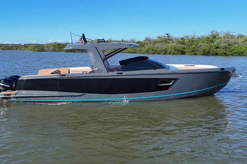 Slide: The Image of 2022 Aviara AV40 OB boat on calm water, sleek design, modern features, and scenic backdrop. - 2