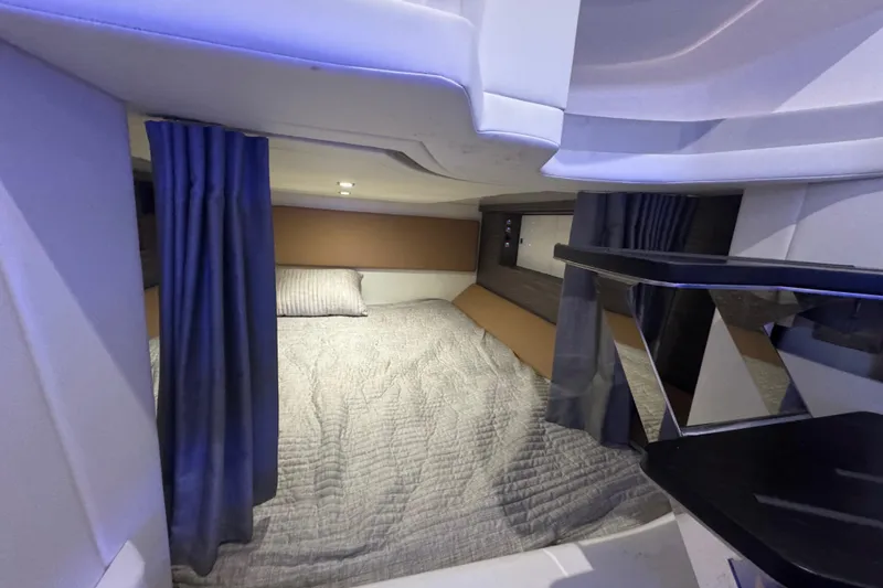Slide: The Image of 2022 Aviara AV40 OB cabin interior with bed, curtains, and modern lighting. - 23