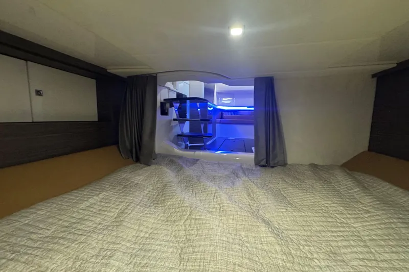 Slide: The Image of Interior cabin of 2022 Aviara AV40 OB boat with modern lighting and cozy bedding. - 25