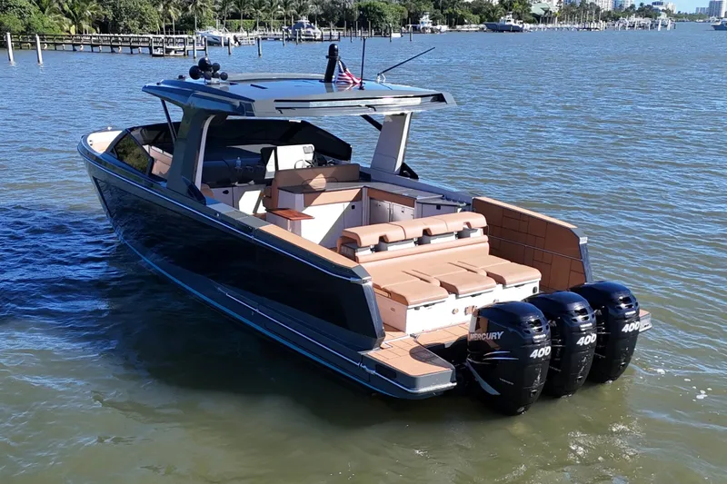 Slide: The Image of 2022 Aviara AV40 OB luxury boat with triple Mercury 400 engines on a sunny day. - 5