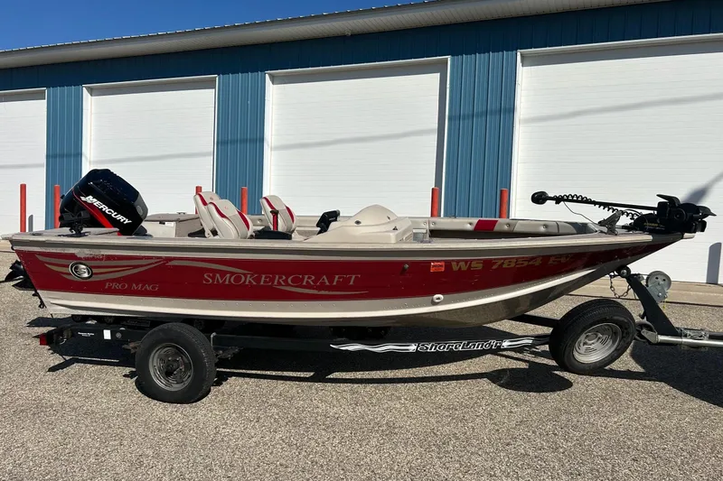 Slide: The Image of 2000 SMOKERCRAFT 161 Pro Mag boat on trailer, red and white, parked outdoors. - 1