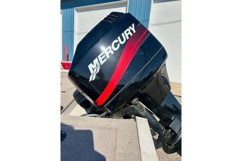 Slide: The Image of Mercury outboard motor on 2000 SMOKERCRAFT 161 Pro Mag boat, parked outdoors. - 14