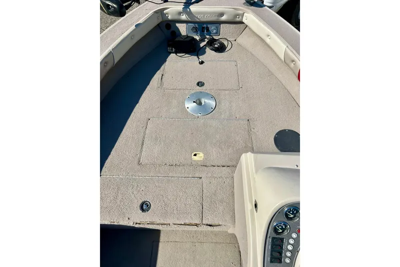 Slide: The Image of 2000 SMOKERCRAFT 161 Pro Mag boat interior with carpeted deck and control panel. - 17