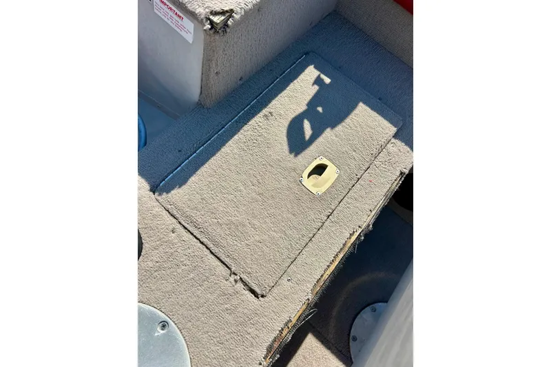 Slide: The Image of 2000 SMOKERCRAFT 161 Pro Mag boat interior with carpeted storage compartment. - 26