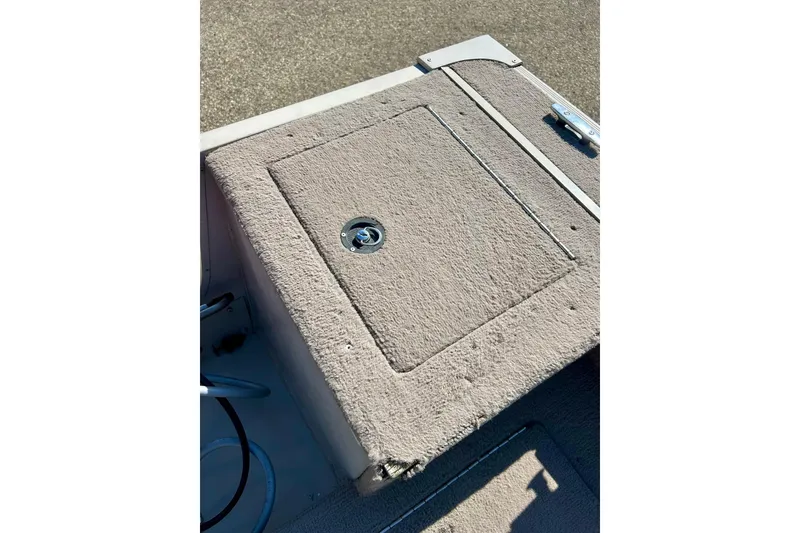 Slide: The Image of 2000 SMOKERCRAFT 161 Pro Mag boat deck with carpeted storage compartment. - 28