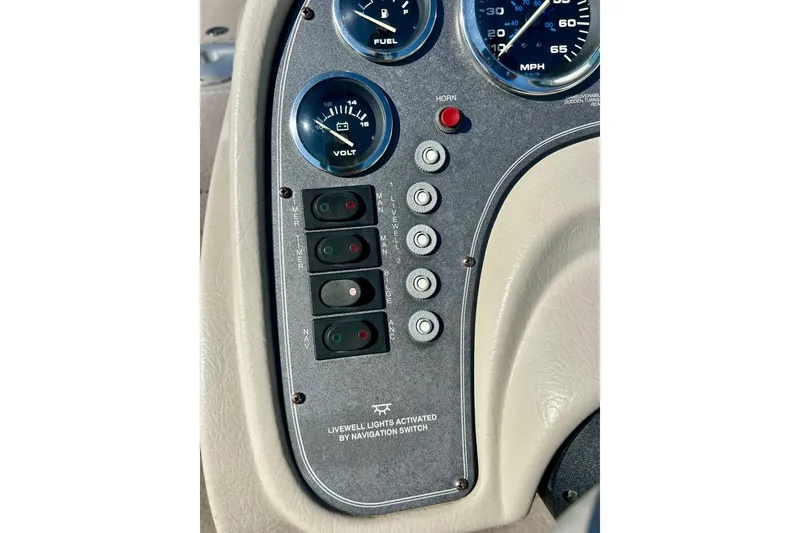 Slide: The Image of Dashboard controls of a 2000 SMOKERCRAFT 161 Pro Mag boat, featuring gauges and switches. - 36