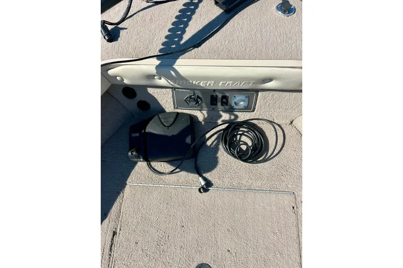 Slide: The Image of 2000 SMOKERCRAFT 161 Pro Mag boat interior with control panel and coiled cable. - 42
