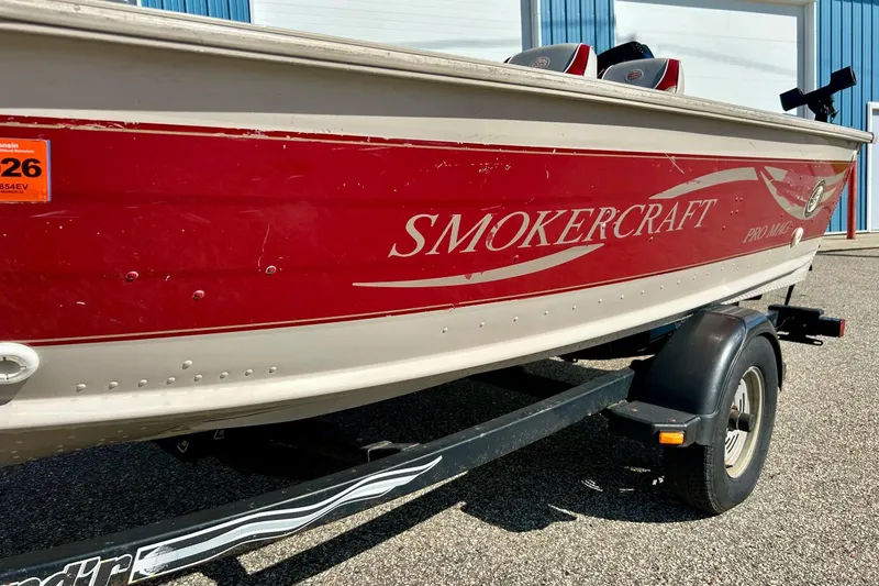 Slide: The Image of 2000 SMOKERCRAFT 161 Pro Mag boat on trailer, red and white design. - 45