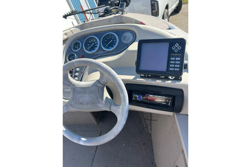 Slide: The Image of 2000 SMOKERCRAFT 161 Pro Mag boat dashboard with steering wheel and electronic display. - 6