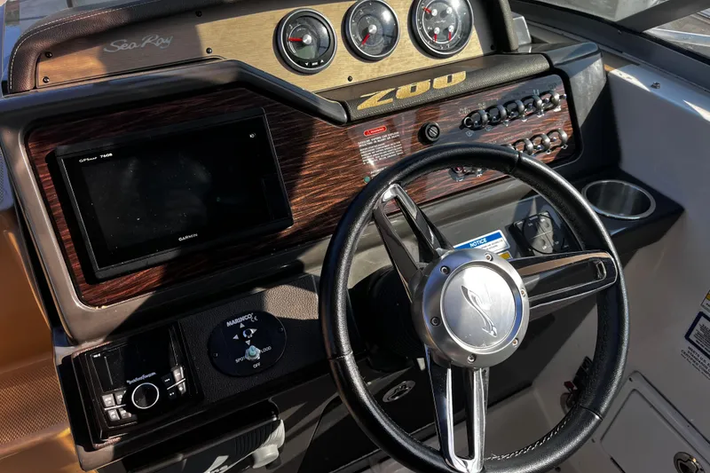 Slide: The Image of Control panel of a 2016 Sea Ray 280 Sundancer boat with steering wheel and gauges. - 12