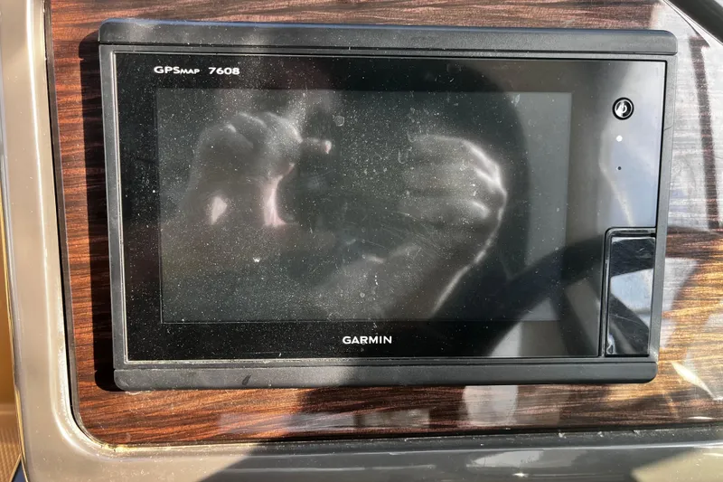 Slide: The Image of Garmin GPSMAP 7608 on 2016 Sea Ray 280 Sundancer dashboard, reflecting sunlight. - 13