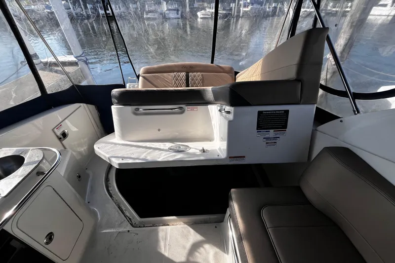 Slide: The Image of Interior of 2016 Sea Ray 280 Sundancer boat with seating and kitchenette area. - 15
