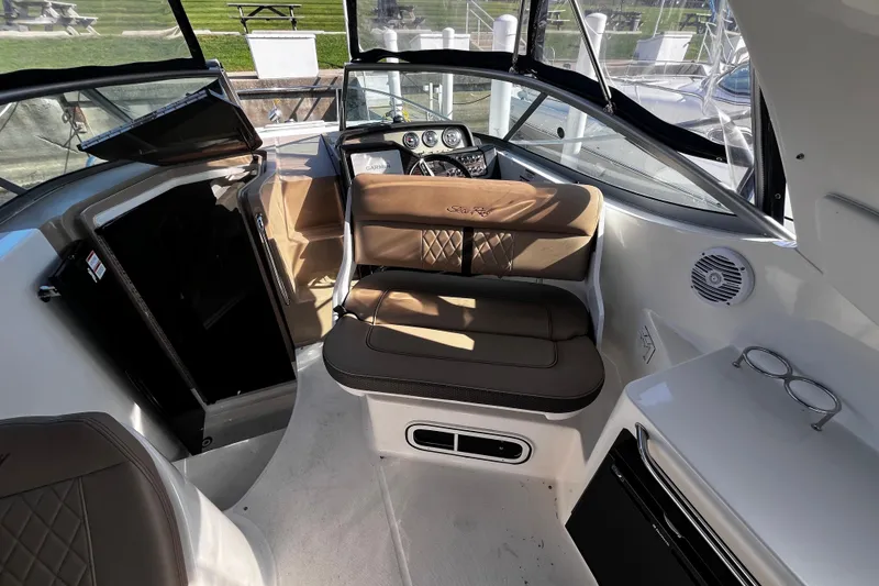 Slide: The Image of Interior of 2016 Sea Ray 280 Sundancer boat with brown seating and control panel. - 16