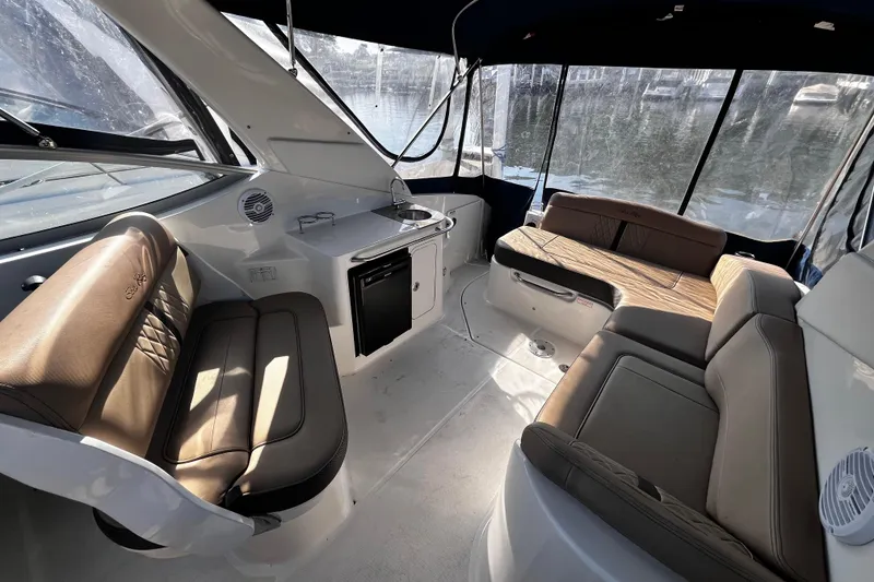 Slide: The Image of Interior of 2016 Sea Ray 280 Sundancer boat with seating and kitchenette. - 17