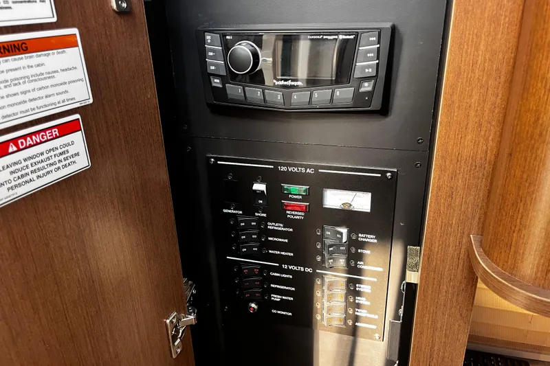 Slide: The Image of Electrical control panel inside 2016 Sea Ray 280 Sundancer boat cabin. - 18