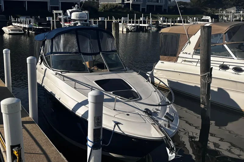 Slide: The Image of 2016 Sea Ray 280 Sundancer docked at marina, featuring sleek design and Garmin equipment. - 2