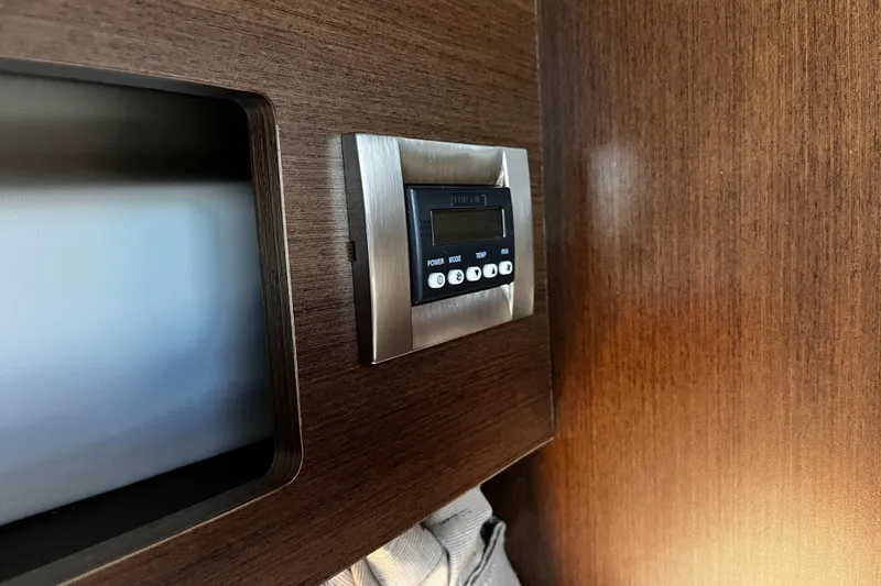 Slide: The Image of Control panel on 2016 Sea Ray 280 Sundancer boat with wood finish interior. - 20