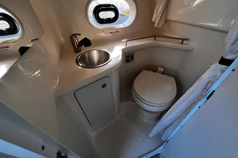 Slide: The Image of Compact bathroom in 2016 Sea Ray 280 Sundancer boat with sink and toilet. - 21